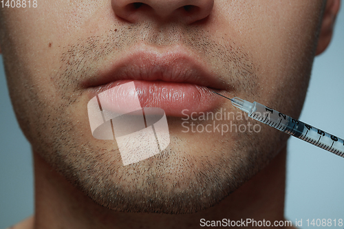 Image of Close-up portrait of young man isolated on grey studio background