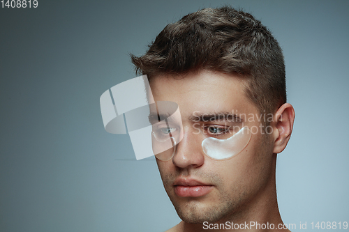 Image of Close-up portrait of young man isolated on grey studio background