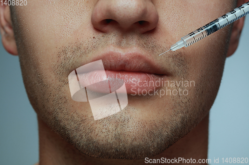 Image of Close-up portrait of young man isolated on grey studio background