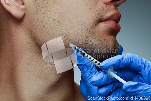 Image of Close-up portrait of young man isolated on grey studio background