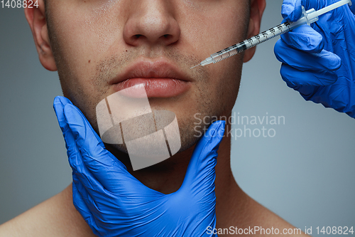 Image of Close-up portrait of young man isolated on grey studio background