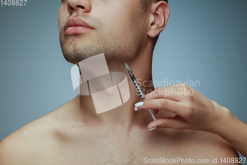 Image of Close-up portrait of young man isolated on grey studio background