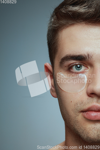 Image of Close-up portrait of young man isolated on grey studio background