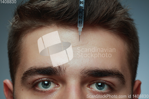 Image of Close-up portrait of young man isolated on grey studio background