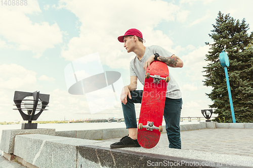 Image of Skateboarder at the city\'s street in sunny day