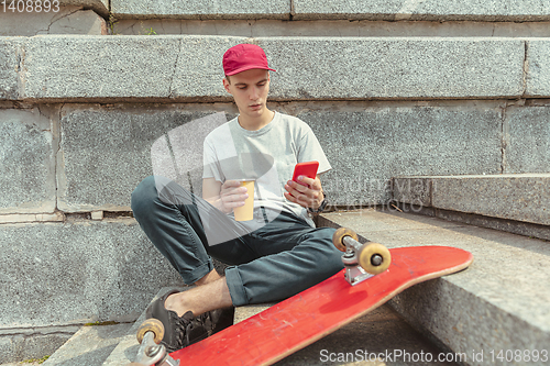 Image of Skateboarder at the city\'s street in sunny day