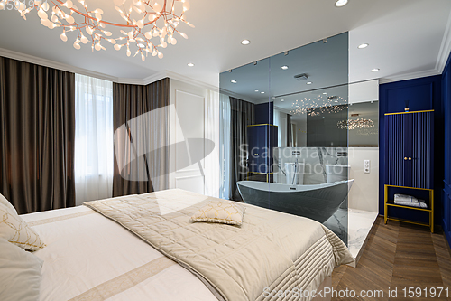 Image of Big comfortable double bed in elegant classic bedroom