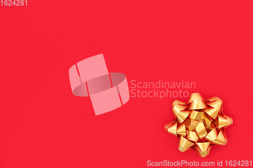 Image of Christmas Gold Ribbon Bow on Red Wrapping Paper