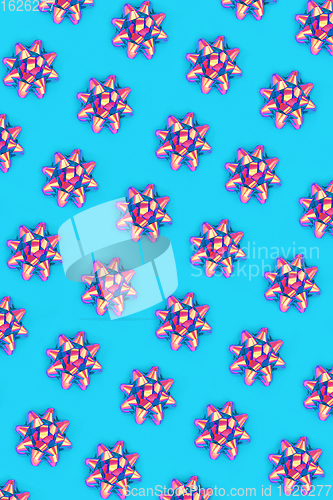 Image of Psychedelic Ribbon Bow Pattern on Pastel Blue