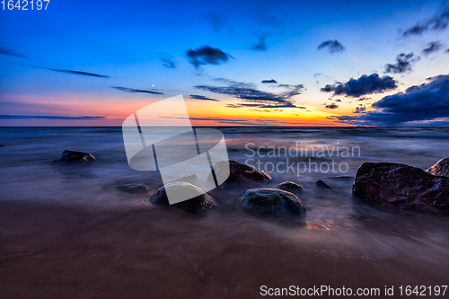 Image of Sea sunset seascape with wet rocks
