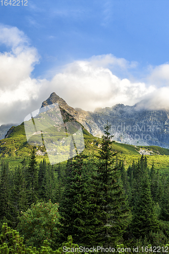 Image of Polish Tatra mountains summer landscape with blue sky and white clouds.