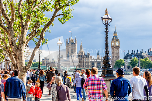 Image of Crowd of people walking on the southern bank of the River Thames, London