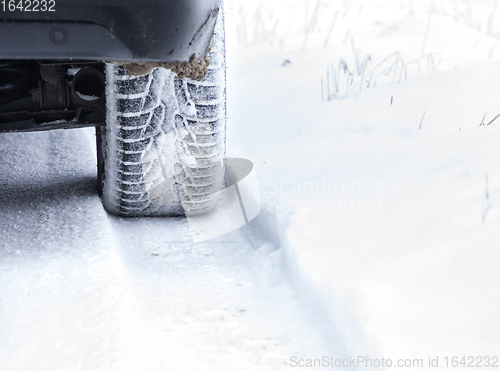 Image of Winter Tyre on snowy country road.