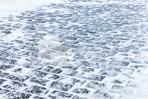 Image of Cobblestone pavement covered with snow and ice