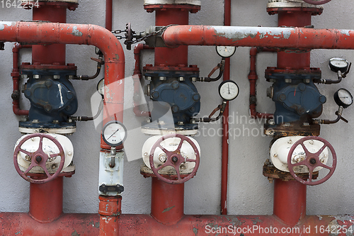 Image of Red pipes with valves and manometers
