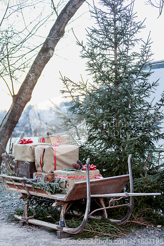 Image of Wooden sledge on the side with presents