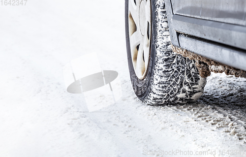 Image of Winter Tyre on snowy country road.