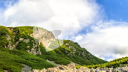 Image of Polish Tatra mountains summer landscape with blue sky and white clouds.