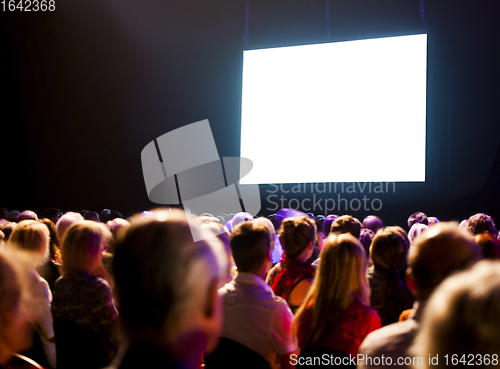 Image of Crowd audience looking at screen