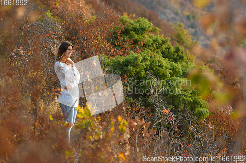 Image of Girl walks in the forest on the mountainside