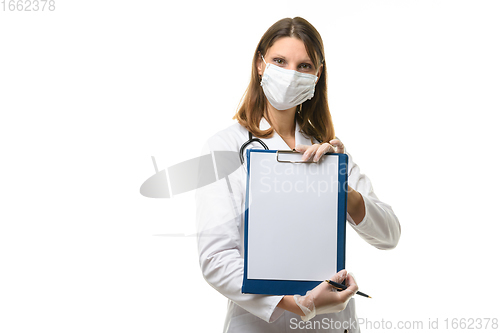 Image of Girl doctor shows a tablet with a blank sheet of paper in front of her