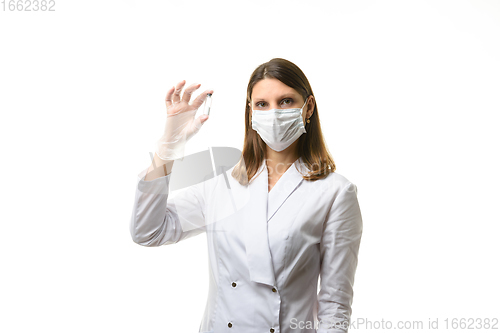 Image of Portrait of a pharmacologist laboratory assistant with a test tube in his hands with white powder