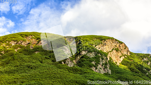 Image of Polish Tatra mountains summer landscape with blue sky and white clouds.