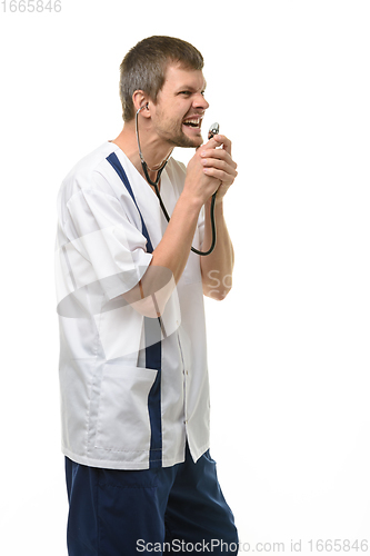 Image of Irritated doctor yelling into stethoscope head isolated on white background