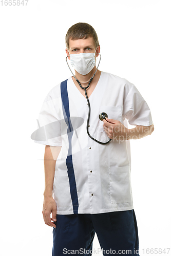 Image of Tired doctor wearing mask listens to his heart with phonendoscope isolated on white background