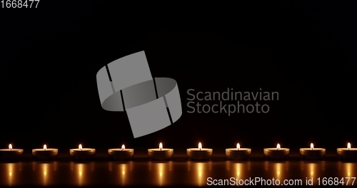 Image of Candles glowing against dark background