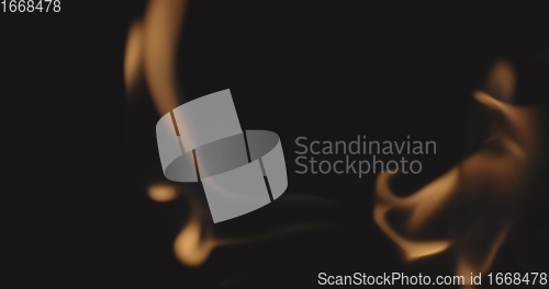 Image of Fire dancing against dark background 120fps slow motion loopable footage