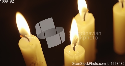 Image of Candles glowing against dark background