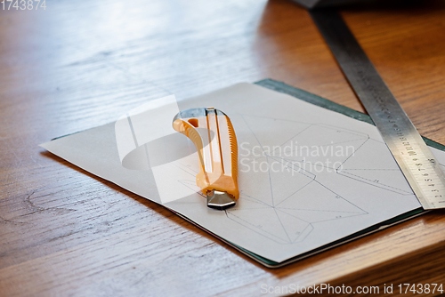 Image of Paper, linear and knife on the table