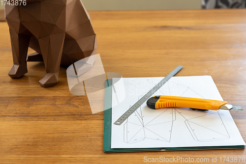 Image of Paper, linear and knife on the table