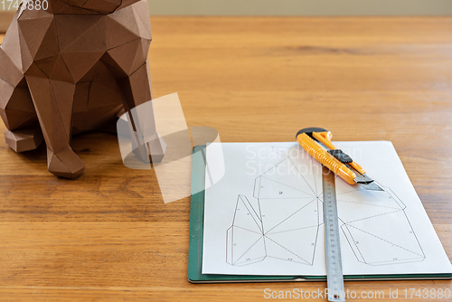 Image of Paper, linear and knife on the table