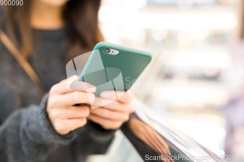 Image of Woman sending sms on cellphone