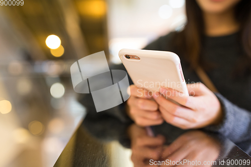 Image of Woman working on cellphone