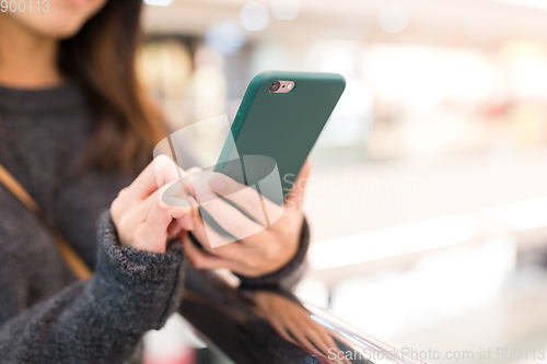 Image of Woman sending sms on cellphone