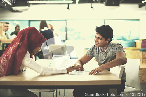 Image of black muslim business woman having a meeting with her indian mal