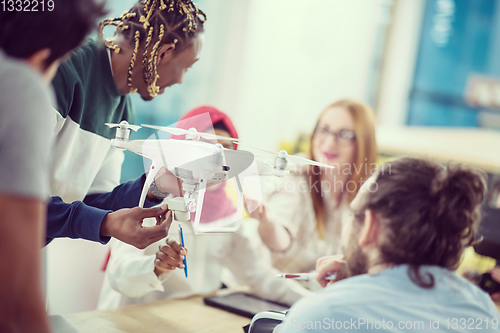 Image of multiethnic business team learning about drone technology