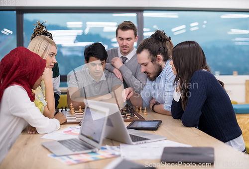 Image of multiethnic group of business people playing chess