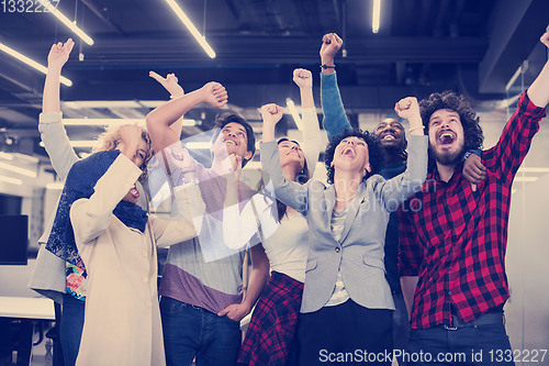 Image of portrait of young excited multiethnics business team