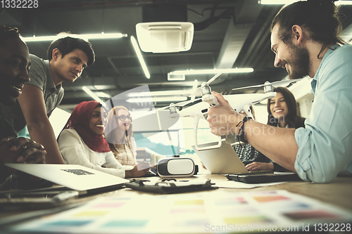 Image of multiethnic business team learning about drone technology