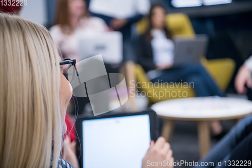 Image of blonde businesswoman using digital tablet