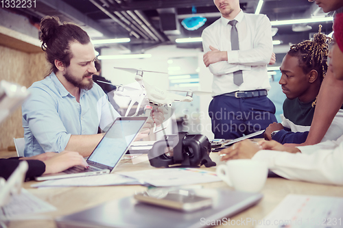 Image of multiethnic business team learning about drone technology