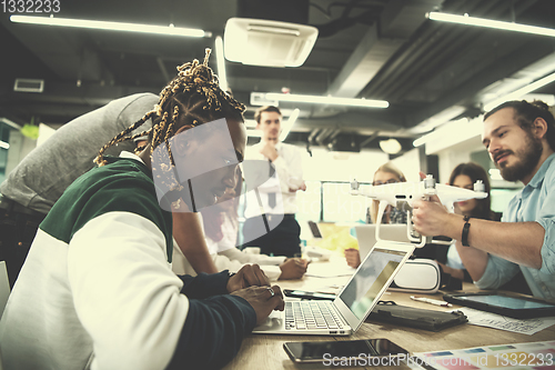 Image of multiethnic business team learning about drone technology