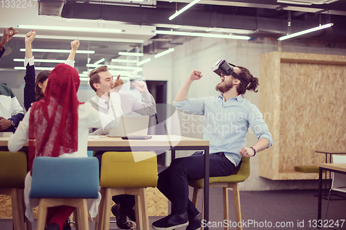 Image of Young Multiethnic Business team using virtual reality headset
