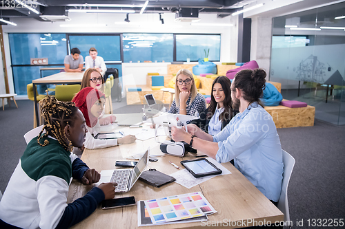 Image of multiethnic business team learning about drone technology