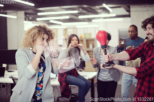 Image of multiethnics business team boxing at office