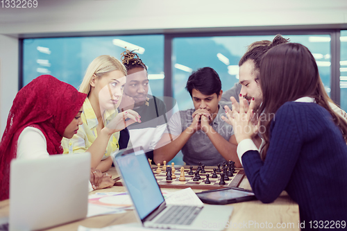 Image of multiethnic group of business people playing chess